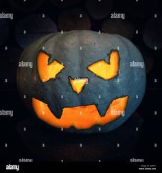 a pumpkin carved to look like a jack - o'- lantern with yellow eyes and mouth