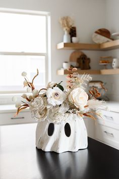 a vase filled with flowers sitting on top of a table