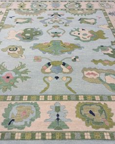 a blue rug with green and pink designs on it