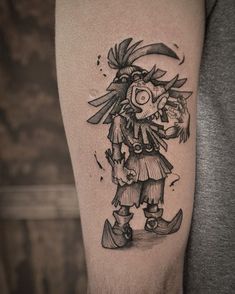 a man's arm with a black and white drawing of a cartoon character on it