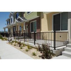 a row of houses with black iron railings