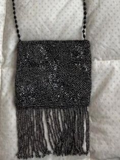 "Beaded, vintage Moyna handbag with fringe.  Beading is grey/silver and strap is black.  Never worn and in new/excellent condition.  Dimensions- 5\" x 4\".  Strap is 22 1/2\".  Pocket for small items inside.  Great handbag for day or night." Rectangular Evening Bag With Fringe, Evening Rectangular Bag With Beaded Fringe, Rectangular Evening Bag With Beaded Fringe, Evening Rectangular Bags With Beaded Fringe, Rectangular Beaded Fringe Evening Bag, Formal Rectangular Bag With Beaded Fringe, Formal Rectangular Bags With Beaded Fringe, Formal Rectangular Evening Bag With Fringe, Evening Shoulder Bag With Beaded Fringe