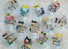 a bunch of wine glasses that are sitting on a white furnishing area with the words disney world painted on them