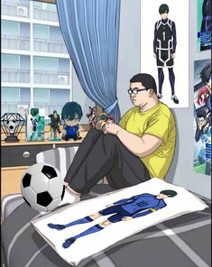 a man sitting on top of a bed in front of a soccer ball and poster