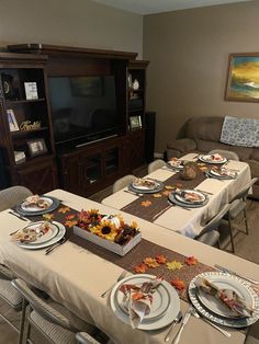 a dining room table is set with plates and place settings for four people to eat