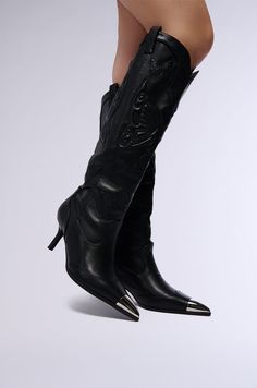 Can I get a yeehaw? The AZALEA WANG Floryan Black Western Boot With Silver Toe Cap is a knee-high cowboy boot crafted from supple faux leather. It features a pointed toe silhouette, a short stiletto heel, a metallic silver toe cap, and tonal butterfly embroidery throughout. It’s complete with convenient pull-on tabs.  - Faux Leather Upper- Pointed Toe- Stiletto Heel- Imported (all measurements approximate from a size 8) - 2.75” Heel Height- 16.75” Shaft Height- 16” Shaft Opening Circumference - 13” Calf Circumference Product ID: 401936 Cowboy Boot Crafts, Knee High Cowboy Boots, Black Western Boots, Short Stiletto, Azalea Wang, Butterfly Embroidery, Western Boot, Cowboy Boot, Stiletto Heel