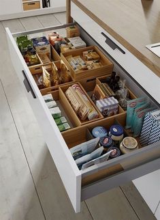 an open drawer in a kitchen filled with food