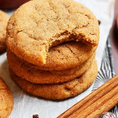 several cookies stacked on top of each other next to cinnamon sticks