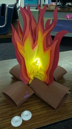 a paper sculpture with fire coming out of it