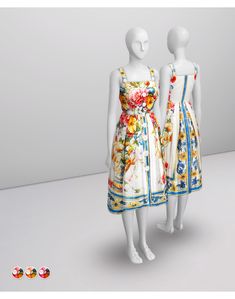 two mannequins dressed in colorful dresses standing next to each other on a white surface