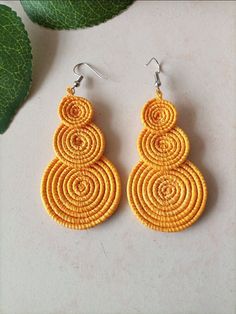 ON SALE African women Earrings, woven wrap earrings, Handmade earrings, African Tribal earrings, Kenyan earrings for women, African Jewelry WE SHIP USING DHL EXPRESS PAY SHIPPING FOR ONLY THE FIRST ITEM IN YOUR CART! These are unique African earrings made of thread. They are lightweight to the wearer.  Drop Length: 3 inches Width: 1.5 inch Material: thread Further Information *We accept PayPal as our primary payment method. PayPal supports payment done via Visa, MasterCard, American Express, and Discover. *We only commence with shipping once payment on all purchases has been received in full. *We ship the packages through DHL, which takes between 3 to 5 days to arrive to you, from date of departure. *We shall use the shipping address that you have provided to us. Therefore, we shall not be Woven Dangle Earrings As Gift, Woven Dangle Earrings For Gift, Round Woven Earrings Ideal For Gifts, Woven Drop Earrings, Woven Round Earrings Perfect For Gifts, Round Woven Earrings For Gift, Yellow Handwoven Earrings For Festival, Macrame Earrings As A Gift, Round Woven Earrings