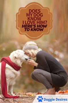 a woman kneeling down next to a white dog with a red scarf around it's neck