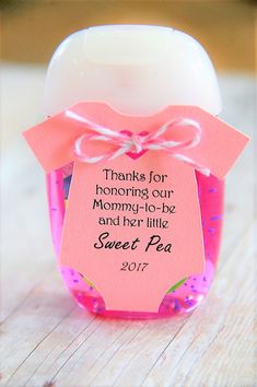 a pink jar filled with baby's first birthday treats and a tag that says thanks for honoring our mommy - in - law and her little sweet pea