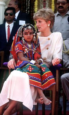 the prince and princess of wales sitting next to each other in chairs at an event