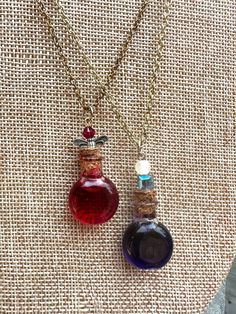 two necklaces that have different colored bottles on them