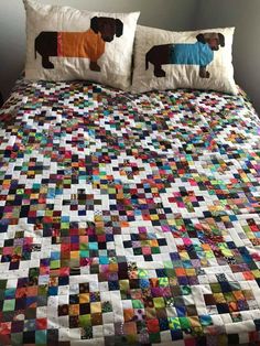 a bed with two pillows on top of it and a quilted dog pillow in the middle