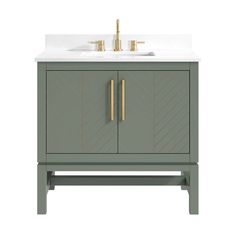 a bathroom vanity with a white sink and two gold faucets on the side