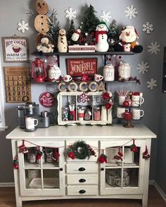 a white table topped with lots of christmas decorations and decorating items on top of it