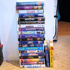 a stack of dvds sitting on top of a carpeted floor