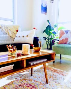 a living room with a couch, coffee table and colorful rug on the floor in front of it