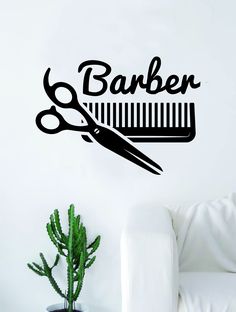 a wall decal that says barber with scissors and combs on it in front of a white couch