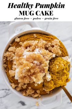 healthy pumpkin mug cake in a white bowl with cinnamon crumbs on top and text overlay