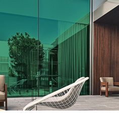 a chair sitting in front of a glass wall