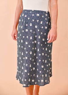 We are loving this fun & flirty midi skirt for any season! A pretty blue and beige floral print dances across this flattering, midi cut, woven fabric as it tumbles from a high waist. Pair this pretty piece with a distressed tee, knit, or a lacy cami for a perfect date-night ensemble! Hidden side zipper Lined 100% Polyester, 100% Rayon (lining) True to size Our model Karin is wearing a size Small Trendy Summer Midi Length Bottoms, Trendy Summer Midi Bottoms, Flowy Rayon Skirt For Spring, Spring Rayon Skirt, Flowy Floral Print Rayon Skirt, Floral Print Flowy Midi Skirt, Flowy Floral Print Midi Skirt, Summer Lined Midi Skirt, Summer Midi Length Lined Skirt