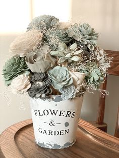 a flower pot sitting on top of a wooden table