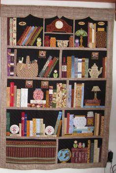 a quilted book shelf with many books on it