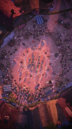 an aerial view of people standing around a large circle