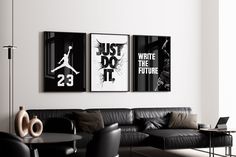 two black and white posters hang on the wall above a couch in a modern living room