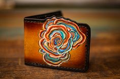 These wallets are cut from high quality vegetable tanned leather, carved, tooled, dyed, stitched, and finished with a protective coating to protect the leather and dye work. The freeform top edge has been wax-hardened for longevity. Colors may vary slightly due to the handmade nature. Made to last. Made with love. Artisan Hand Tooled Leather Wallet, Turkey Tail Mushroom, Tooled Leather Wallet, Turkey Tail, Leather Bifold Wallet, Tooled Leather, Black Interior, Vegetable Tanned Leather, Leather Tooling