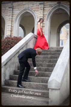 a woman in a red dress and a man in a black suit on some stairs