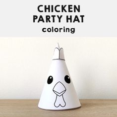 a chicken party hat sitting on top of a wooden table