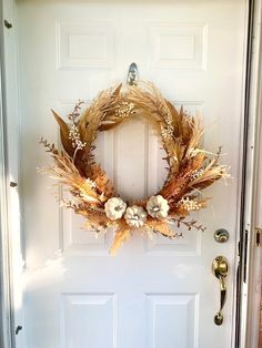 a white door with a wreath on it