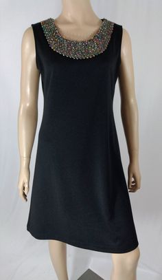 "Women's Dress Sleeveless Excellent Condition Designer by RONNI NICOLE Size 6 Lux Expensive Designer Chic! Black classic sleeveless dress in lux thick RAYON spandex blend fabric, amazing simple unique high taste chic design, scoop neck with colorful heavily beaded neck line, great silhouette. Super high quality. PERFECT GO-TO DRESS. Excellent condition. Easy to wear casual chic vintage for the disco sporting life. MEASUREMENTS: Length - 35.5\" Bust (underarms to underarms) - 38\" Sleeve (shoulde Sleeveless Beaded Formal Dress, Formal Sleeveless Beaded Mini Dress, Formal Beaded Sleeveless Mini Dress, Formal Beaded Sleeveless Dress, Formal Sleeveless Beaded Dress, Women's Black Dress, Black Dress Sleeveless, Beaded Neckline, Designer Vintage