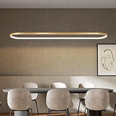 a dining room table with white chairs and a long rectangular light fixture hanging over it