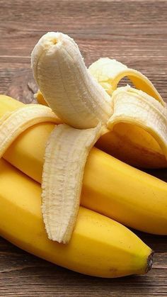 a bunch of bananas sitting on top of a wooden table