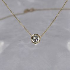 Our most requested necklace for the holidays, featuring a timeless half carat solitaire diamond necklace. Simplistic beauty with unparalleled sophistication. DETAILS: - .50 carat solitaire diamond, G SI+, 5.5 mm - Set in a 14k gold bezel setting - 14k gold cable chain with a lobster clasp closure, 0.5 mm - Custom/larger chains are available upon request - Available in 14k white, yellow or rose gold - Sizes 15 - 20 inches *18k gold and custom lengths available upon request **GIA or EFL certified Bezel Set Diamond Necklace, Timeless Diamond White Solitaire Necklace, Timeless Solitaire Necklace With Single Diamond For Formal Occasions, Timeless Solitaire Necklace For Anniversary, Minimalist Brilliant Cut Diamond Necklace For Formal Events, Minimalist Brilliant Cut Diamond Necklace For Formal Occasions, Timeless Solitaire Diamond Necklace, Minimalist Diamond Solitaire Necklace For Formal Occasions, Bezel Diamond Necklace