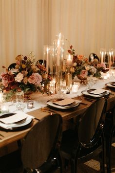 a long table with candles, plates and flowers is set up for a formal dinner