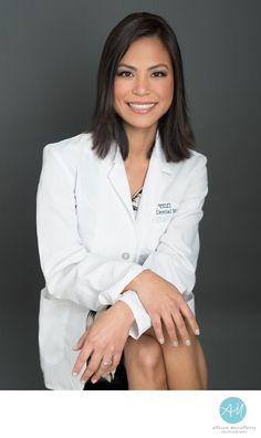 a woman in a white lab coat posing for a photo