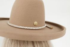 In coordination with Gigi Pip's first collaboration hat with Cara Loren, we're excited to introduce the Cara Loren braided leather hat band. To compliment Cara's neutral loving style, we created a white, thick braided rope band with genuine leather + gold hardware. This hat band is a one size fits all band that is adjustable. Pull the tails of the band to tighten once the band is around the crown of your hat. Shop The Cara Loren hat in Off White and Tan. Shop the Cara Loren Bolo Hat Band for a d Adjustable Everyday Hats, Elegant Everyday Hat Band With Flat Crown, Chic Adjustable Hat Bands, Elegant Adjustable Beige Hat Bands, Adjustable Gold Hats For Fall, Adjustable Gold Hat For Fall, Adjustable Chic Hats For Everyday, Chic Adjustable Hats For Everyday Wear, Adjustable Beige Hat Band For Everyday