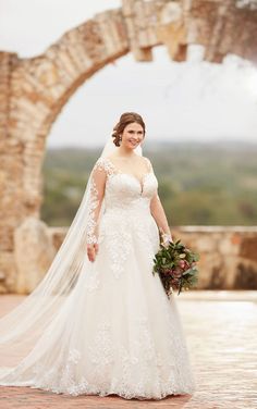 a woman in a wedding dress is posing for the camera