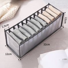 an image of a drawer that has folded clothes in it and measurements for the drawers