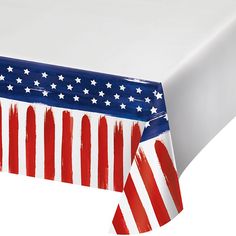 an american flag tablecloth with red, white and blue paint splattered on it