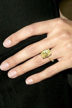 a close up of a person's hand wearing a ring