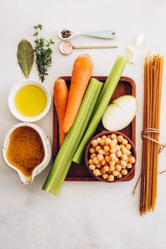 carrots, celery, beans and other ingredients on a tray