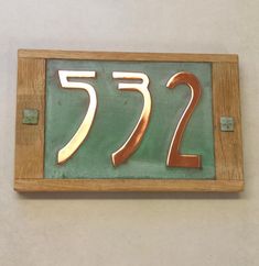 a wooden plaque with the number seventy seven on it