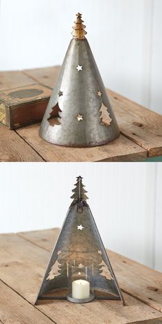 a metal christmas tree shaped candle holder sitting on top of a wooden table